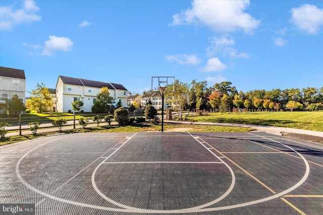 view of basketball court with a lawn