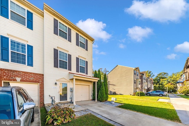 multi unit property featuring a front lawn and a garage