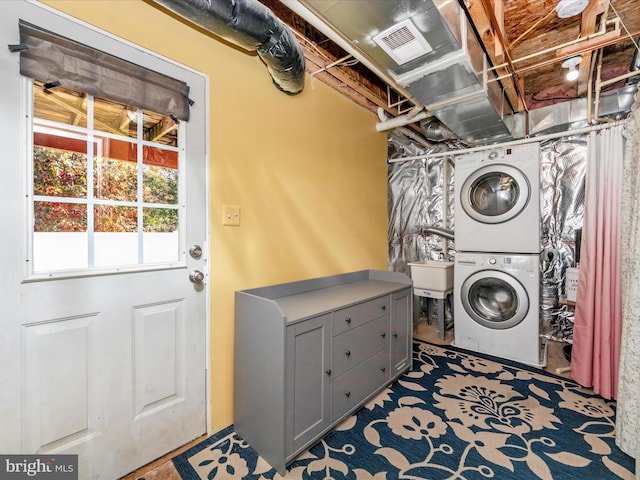 laundry room featuring sink and stacked washer and dryer