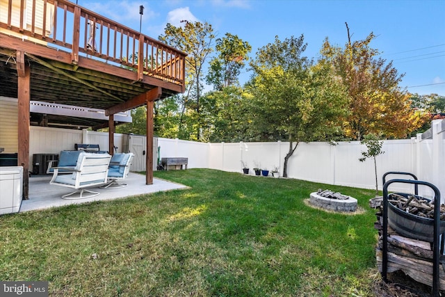 view of yard featuring an outdoor fire pit, a patio area, a deck, and central air condition unit