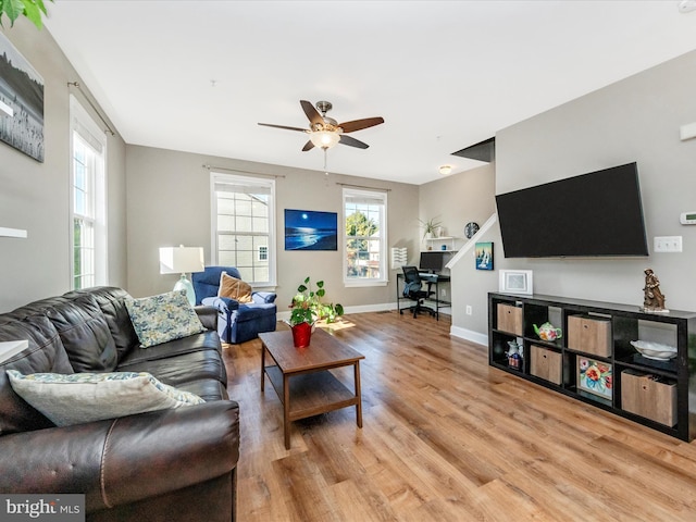 living room featuring light hardwood / wood-style flooring and ceiling fan