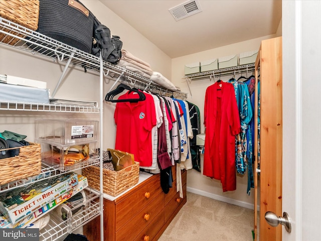 spacious closet with light colored carpet