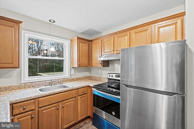 kitchen with sink, hanging light fixtures, light stone counters, a notable chandelier, and appliances with stainless steel finishes