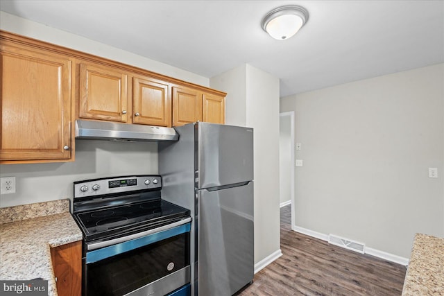 kitchen with light stone counters, dark wood-type flooring, and stainless steel appliances