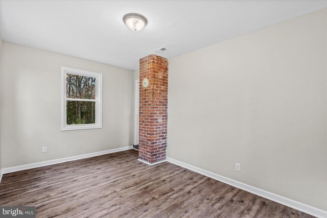 spare room with dark hardwood / wood-style flooring