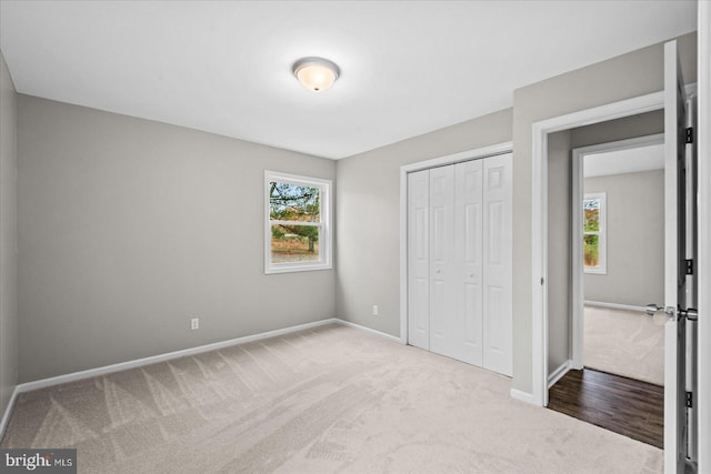 unfurnished bedroom with carpet flooring and a closet