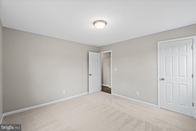 unfurnished bedroom featuring light colored carpet