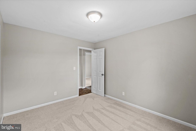 unfurnished bedroom featuring light carpet