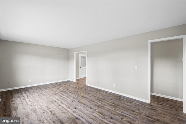 spare room with dark wood-type flooring