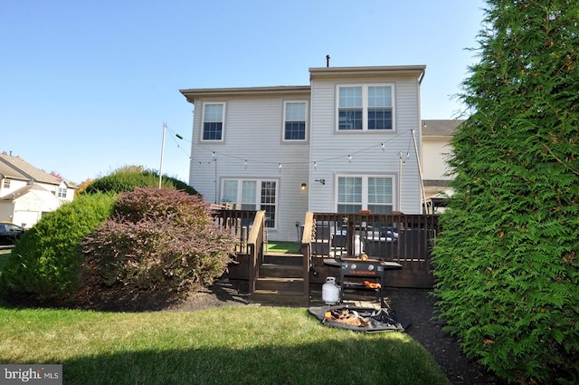 back of property featuring a yard and a deck