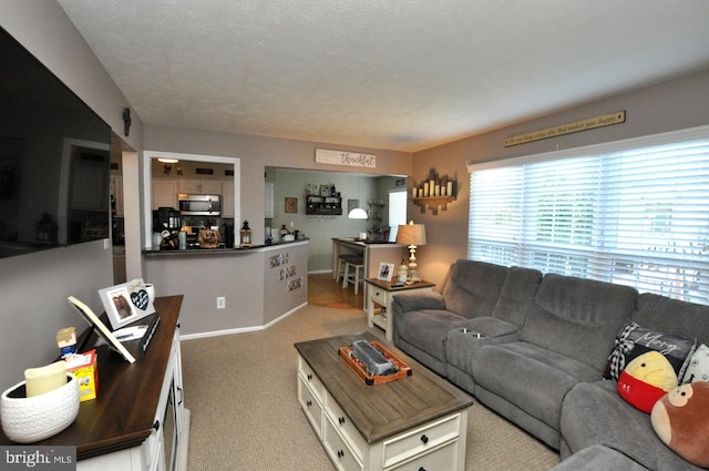 carpeted living room featuring a textured ceiling