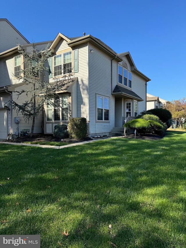 back of house with a lawn