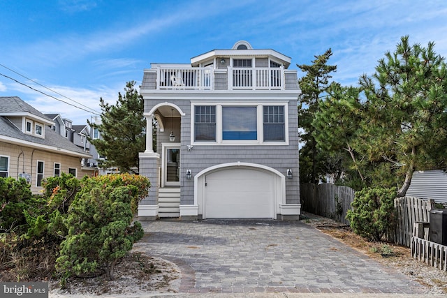 view of front facade with a garage and a balcony