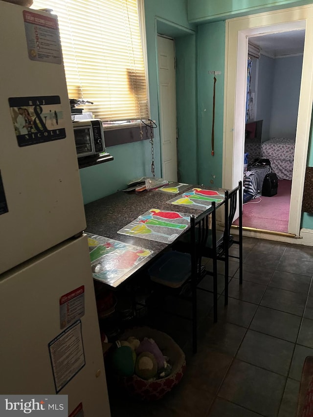 dining room with dark tile patterned floors