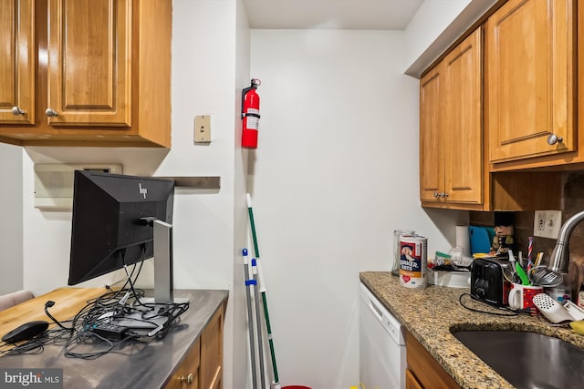 kitchen with stone counters, dishwasher, and sink