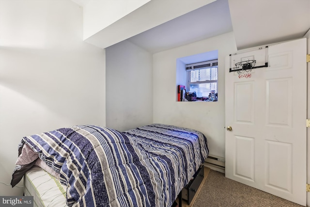 carpeted bedroom with a baseboard heating unit