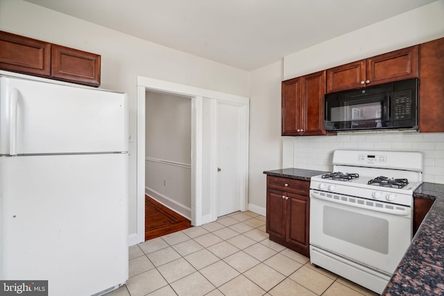 kitchen with light tile patterned floors, white appliances, and tasteful backsplash