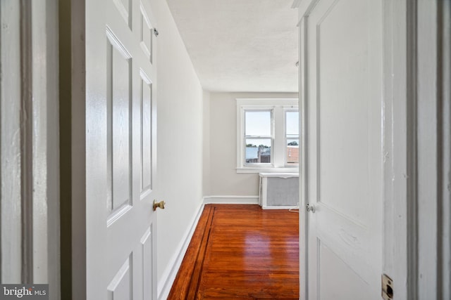 corridor with wood-type flooring