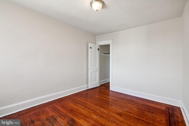 unfurnished room featuring dark hardwood / wood-style flooring