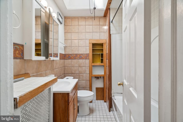 full bathroom with toilet, shower / bath combination, tile patterned floors, tile walls, and vanity