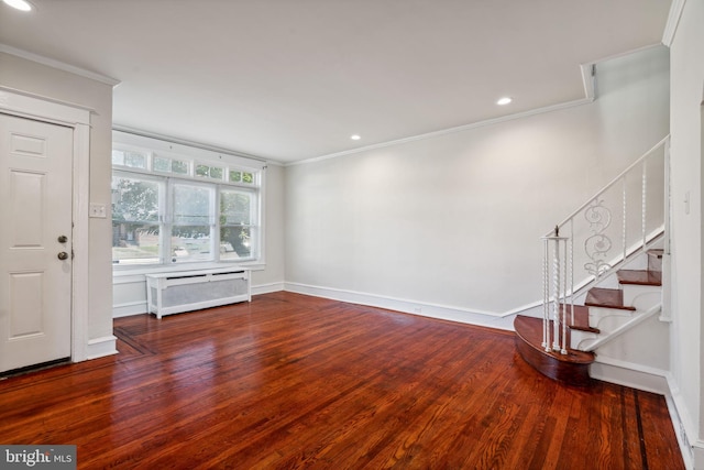 unfurnished living room featuring crown molding and hardwood / wood-style floors