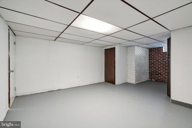 basement with a paneled ceiling