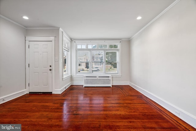 foyer entrance featuring crown molding and dark hardwood / wood-style floors