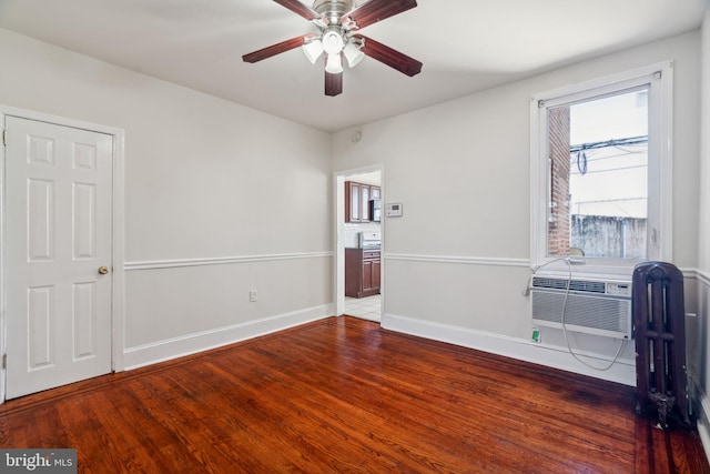 empty room featuring hardwood / wood-style floors and ceiling fan