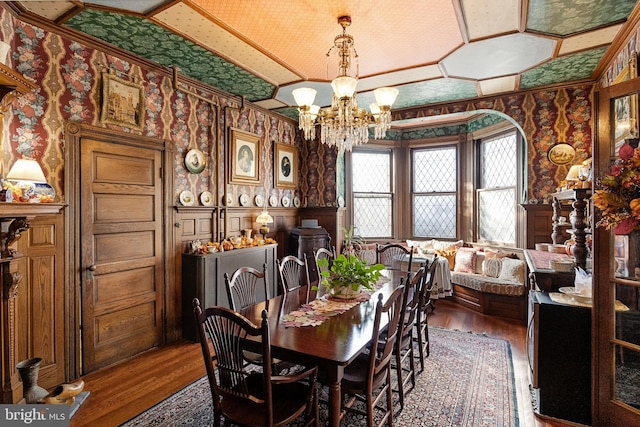 dining room with a notable chandelier and dark wood-type flooring