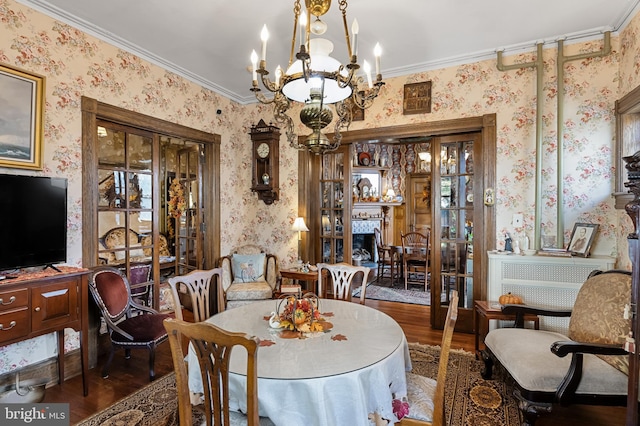 dining room featuring crown molding and dark hardwood / wood-style flooring