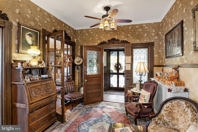 living area featuring ornamental molding, hardwood / wood-style floors, and ceiling fan