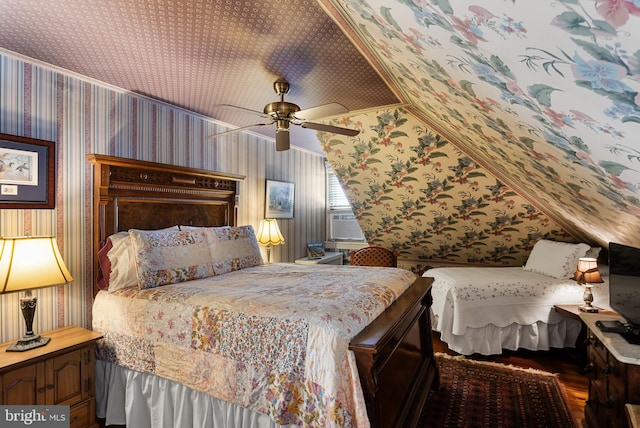 bedroom featuring vaulted ceiling, cooling unit, hardwood / wood-style flooring, and ceiling fan