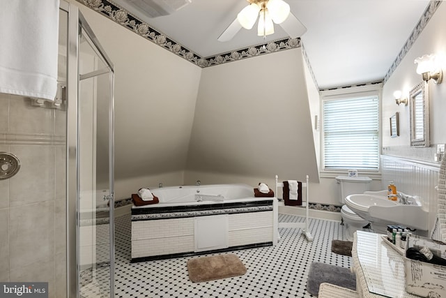 bathroom with a shower with door, toilet, and ceiling fan