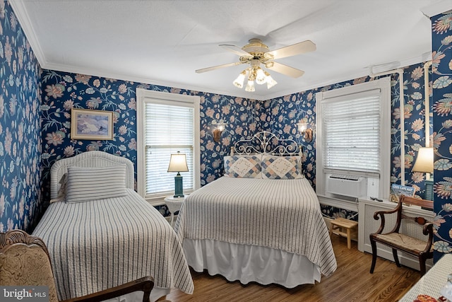 bedroom with ceiling fan, cooling unit, a textured ceiling, dark wood-type flooring, and crown molding