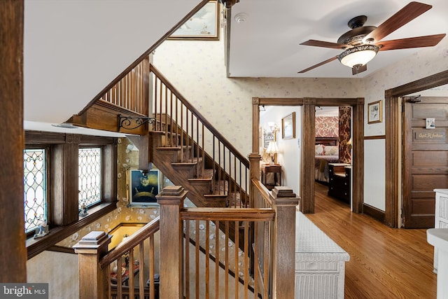 stairway featuring hardwood / wood-style floors and ceiling fan