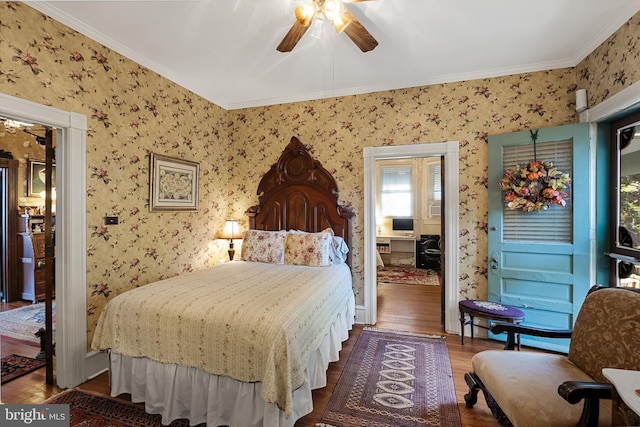 bedroom with crown molding, hardwood / wood-style flooring, and ceiling fan