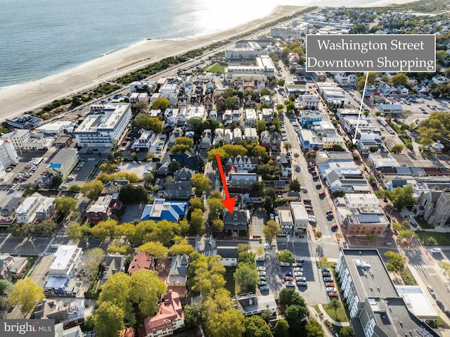 bird's eye view with a water view and a view of the beach