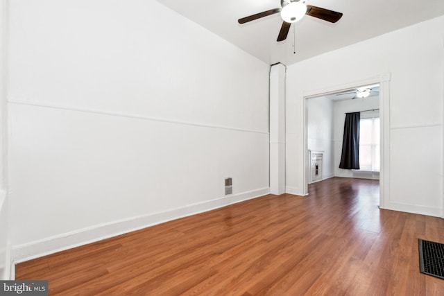 empty room with ceiling fan and hardwood / wood-style flooring