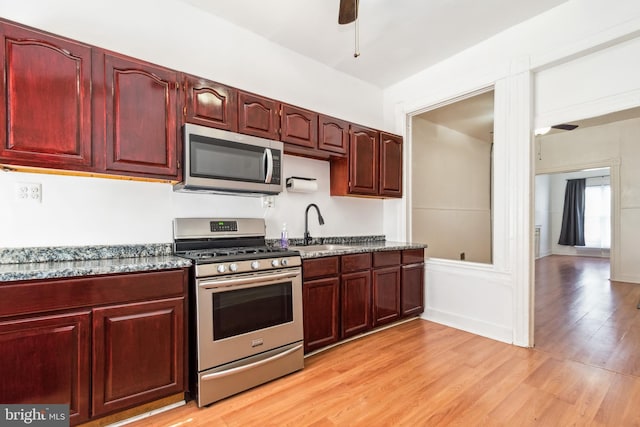 kitchen featuring light hardwood / wood-style flooring, stainless steel appliances, sink, and ceiling fan