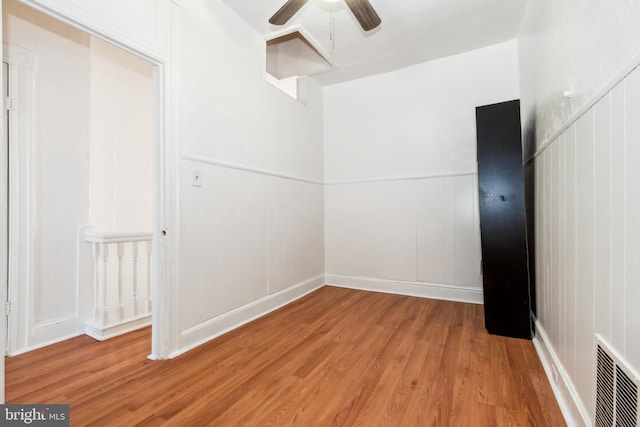 spare room with light hardwood / wood-style floors and ceiling fan