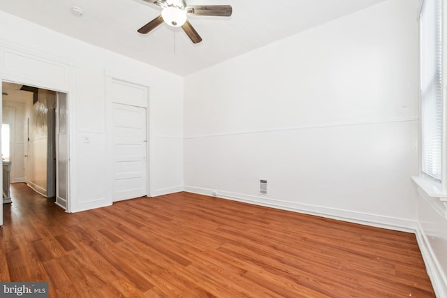 empty room featuring wood-type flooring and ceiling fan