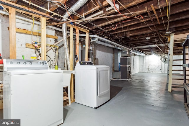 basement with washing machine and dryer and heating unit