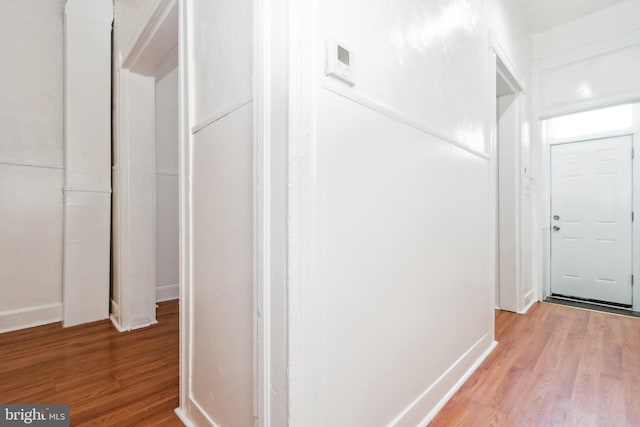 corridor with light wood-type flooring