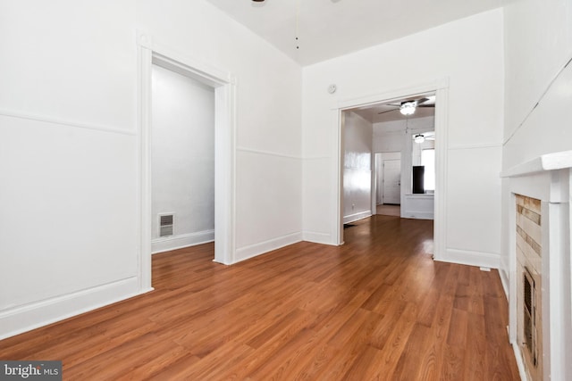 interior space featuring hardwood / wood-style floors, a fireplace, and ceiling fan