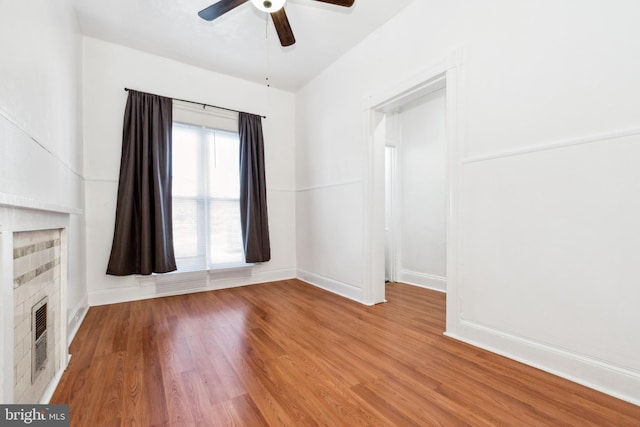 unfurnished living room featuring hardwood / wood-style flooring and ceiling fan