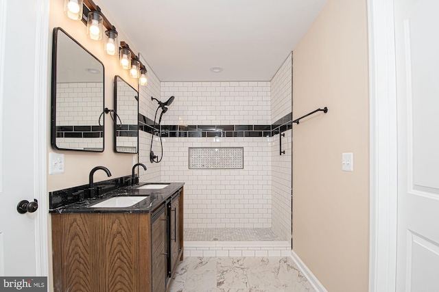 bathroom with vanity and a tile shower