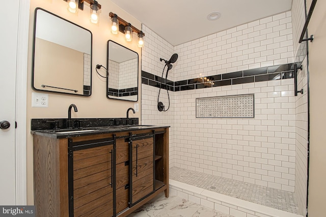 bathroom with vanity and tiled shower