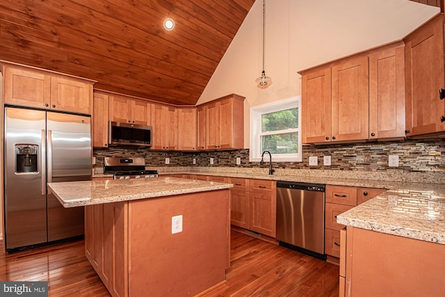 kitchen with light hardwood / wood-style flooring, a center island, pendant lighting, appliances with stainless steel finishes, and high vaulted ceiling