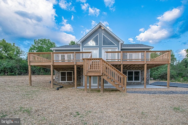 back of house with a wooden deck