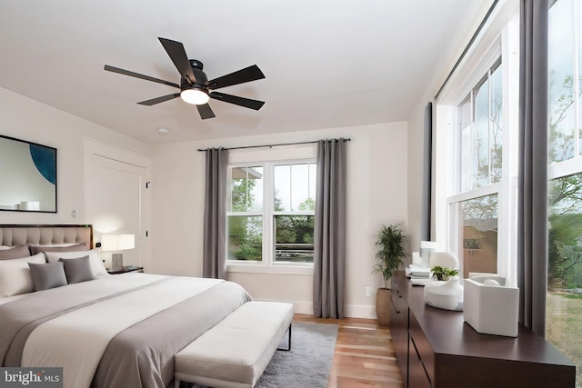 bedroom featuring ceiling fan and light hardwood / wood-style flooring